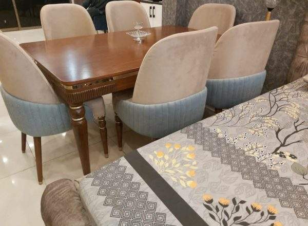 Contemporary dining table with six fabric chairs and wooden dining table design