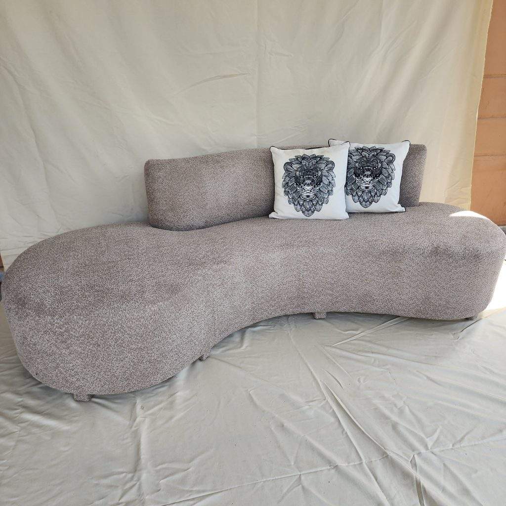 Cika curved couch in Pakistan with cream textured upholstery and rounded design