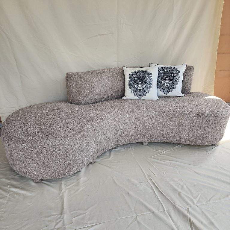 Cika curved couch in Pakistan with cream textured upholstery and rounded design