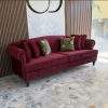 Interior styling inspiration showing how a maroon Chesterfield sofa can complement neutral walls, warm wood, decorative lighting and modern living room furniture.