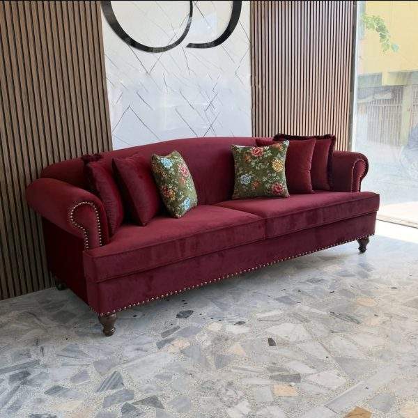 Interior styling inspiration showing how a maroon Chesterfield sofa can complement neutral walls, warm wood, decorative lighting and modern living room furniture.